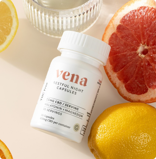 Angled front view of Restful Night CBD bottle showing Vena label and 15 mg CBD with citrus halves on peach background