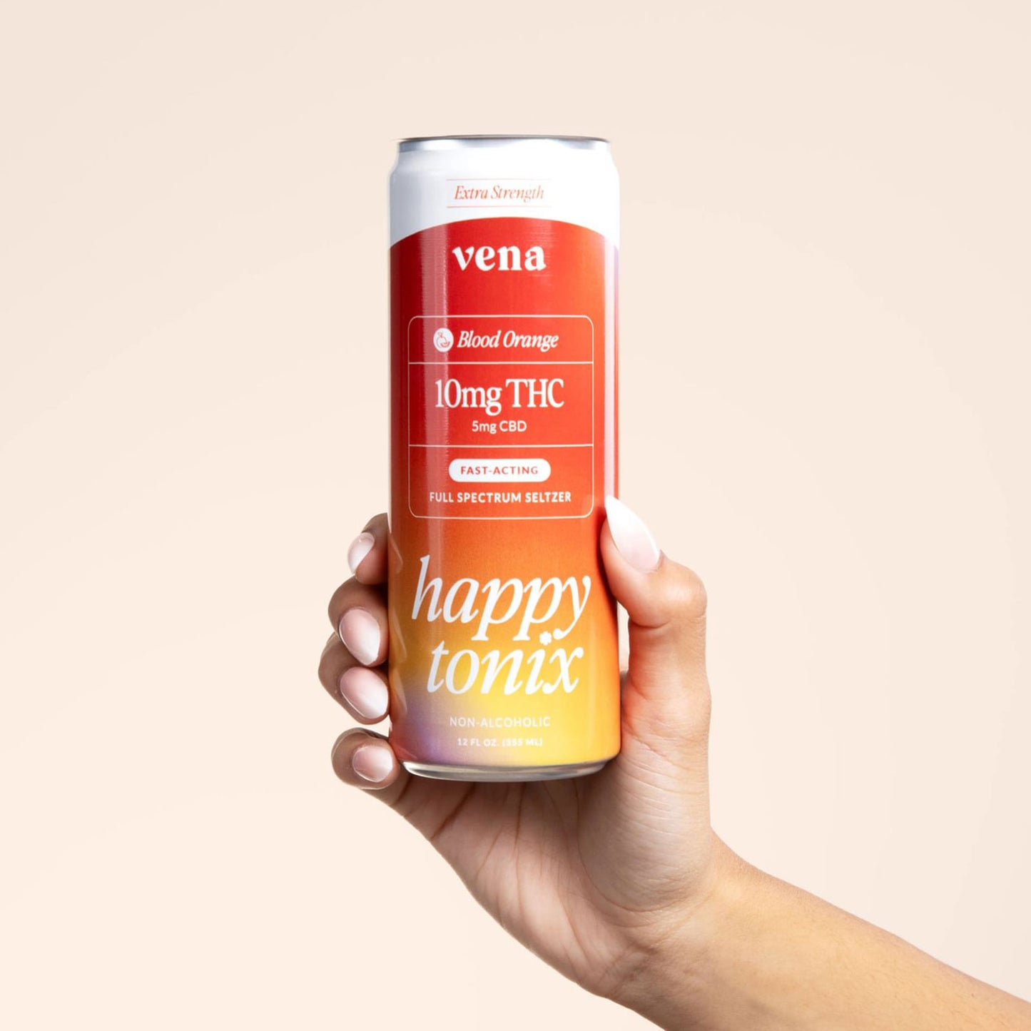 Front view of Blood Orange THC seltzer can held in hand showing 10mg THC/5mg CBD label and happy tonix on peach background