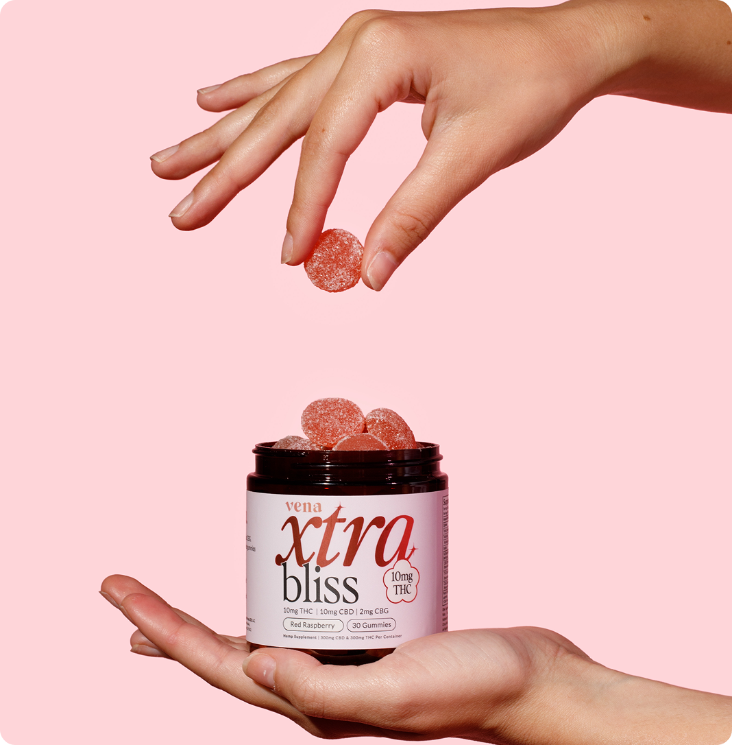 Hands holding jar of xtra bliss gummies; label reads: vena xtra bliss 10mg THC 10mg CBD 2mg CBG Red Raspberry 30 Gummies