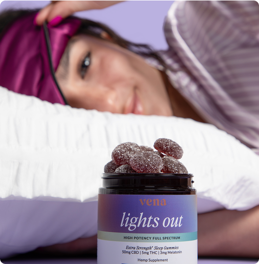 Jar labeled 'vena lights out' HIGH POTENCY FULL SPECTRUM, on pillow with person wearing sleep mask in background.