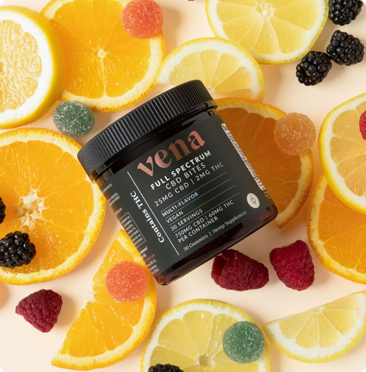 Angled jar of Vena Full Spectrum CBD Bites showing label 25 mg CBD and 2 mg THC per gummy with multi-flavor vegan gummies on a citrus and berry slice background