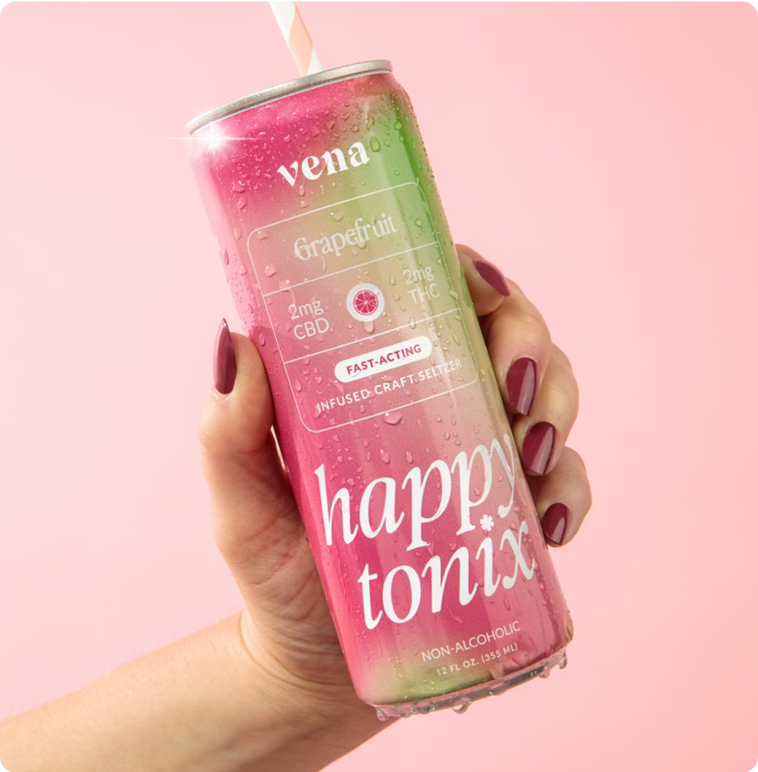 Angled can of Happy Tonix Grapefruit seltzer held in hand showing 2mg CBD 2mg THC fast-acting, condensation, pink background