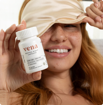 Front view of Restful Night CBD and Melatonin capsules bottle showing 15 mg CBD per serving held by smiling woman with silk sleep mask