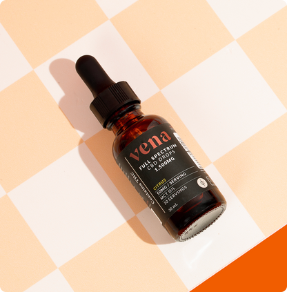Angled view of Vena full spectrum CBD and Delta 9 THC tincture bottle with citrus label and dropper on peach checkerboard