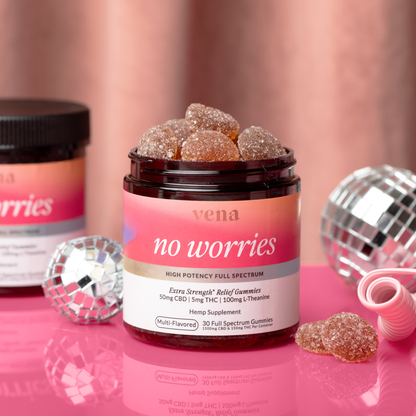 vena 'no worries' jar labeled HIGH POTENCY FULL SPECTRUM, CBD gummies on pink surface with disco balls