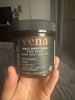 Jar of Vena brand cream with dark label held in hand, orange 'vena' logo visible.