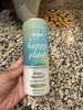 Handheld front view of Happy Tonix My Happy Place spray bottle showcasing teal gradient label and white cap with pebble background